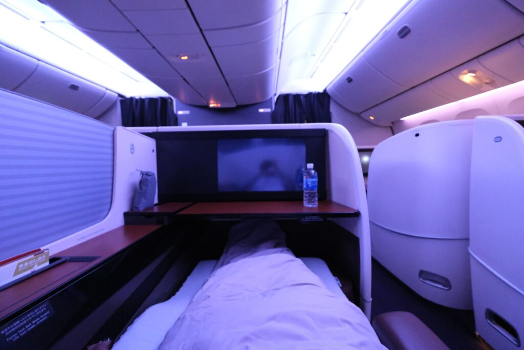 JAL First class lie-flat seat in sleeping mode