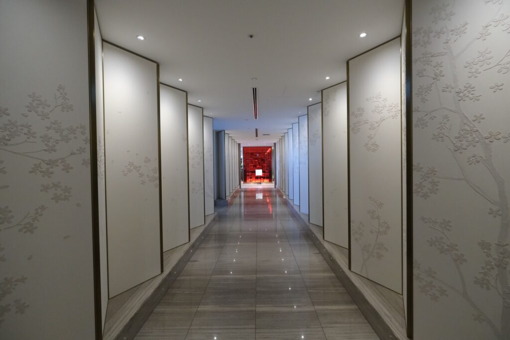 the White panel hallway adds to the Japanese vibe of the lounge.  
