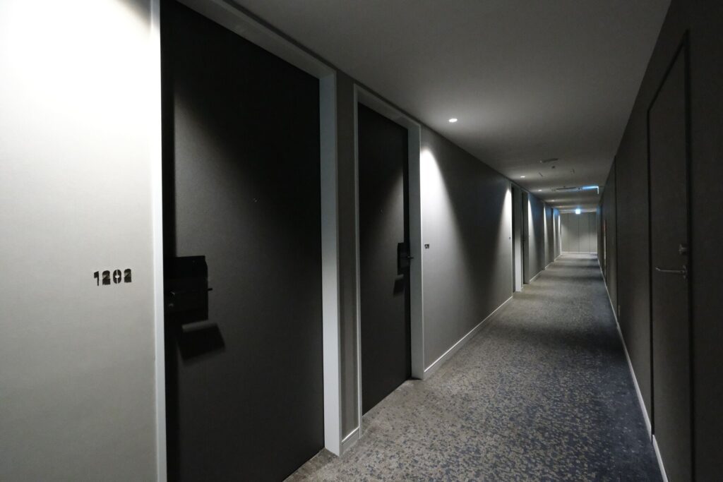 Hallway leading towards my room - the design is modern and elegantly lit.
