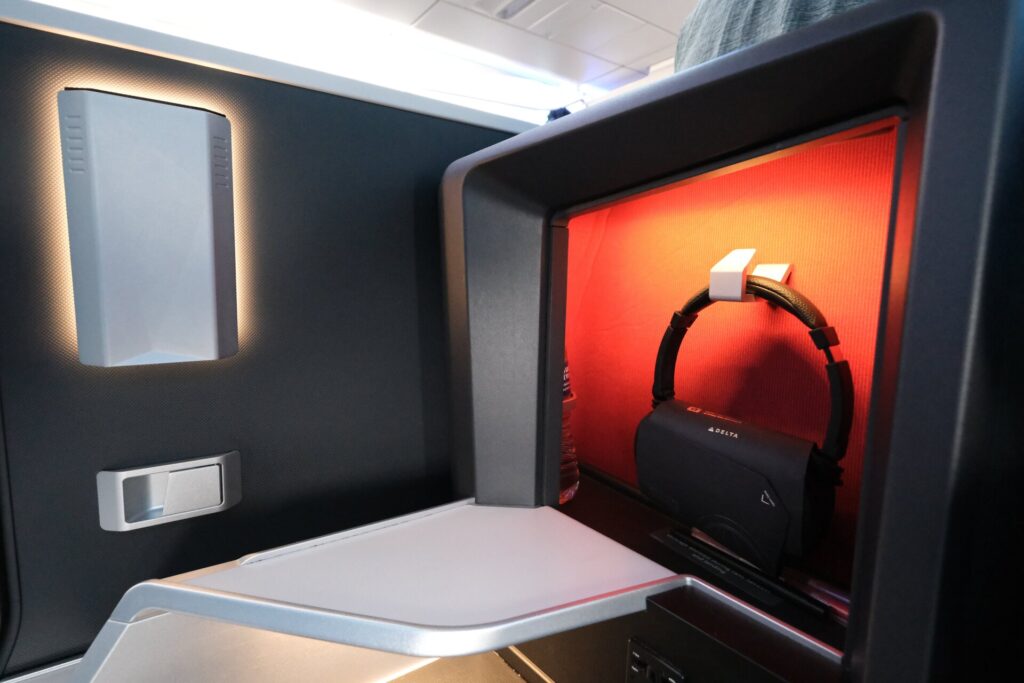 Here is the red storage area with some stylish lighting, which includes a water bottle and Delta’s standard headsets