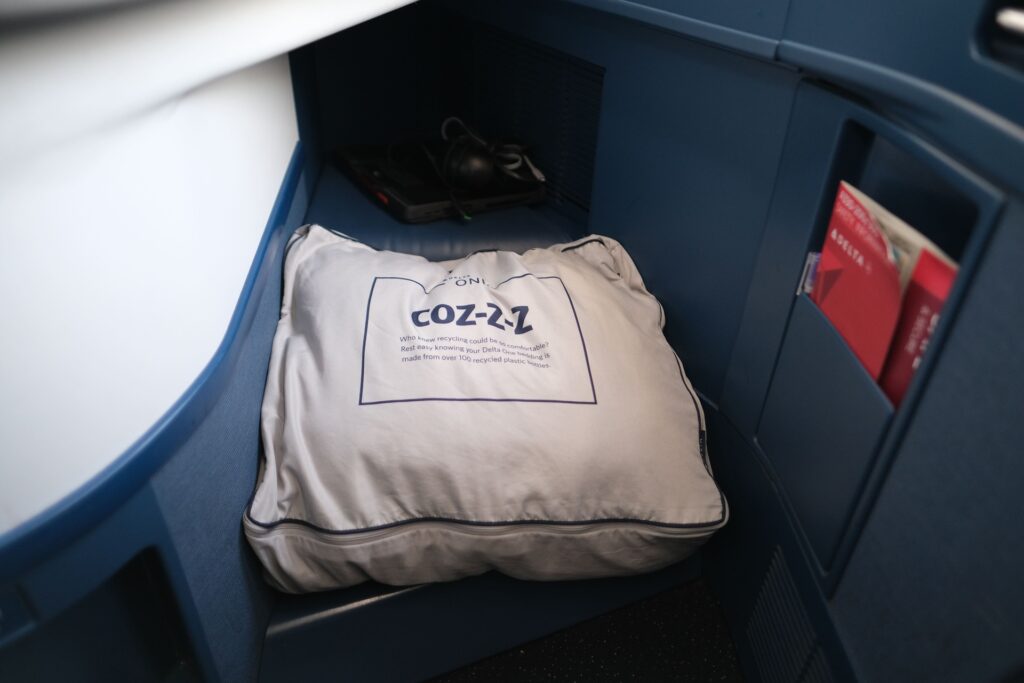 the Delta one storage is spacious, although it  encroached on your legroom. A pillow and blanket set is provided.