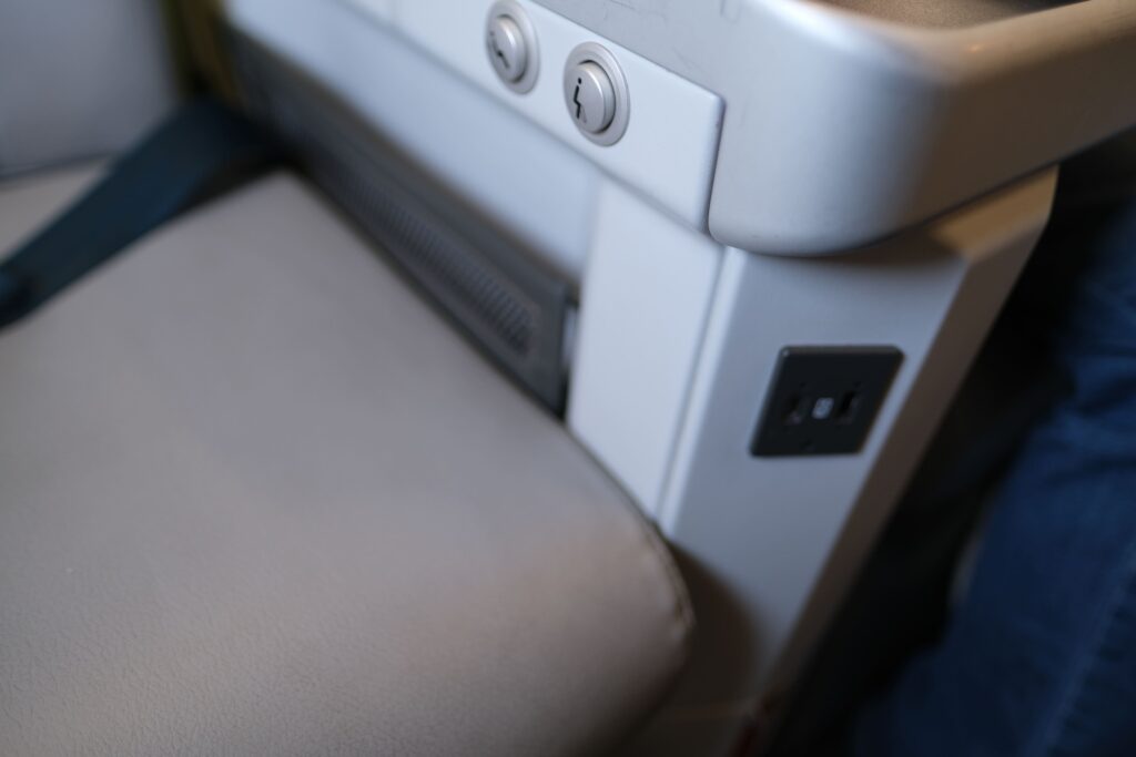 Two button controls for reclining your seat and the USB C ports for phone charging.