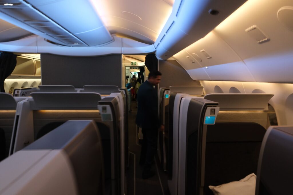 Isle view of Oman Air First Class with the lead FA beside my seat.