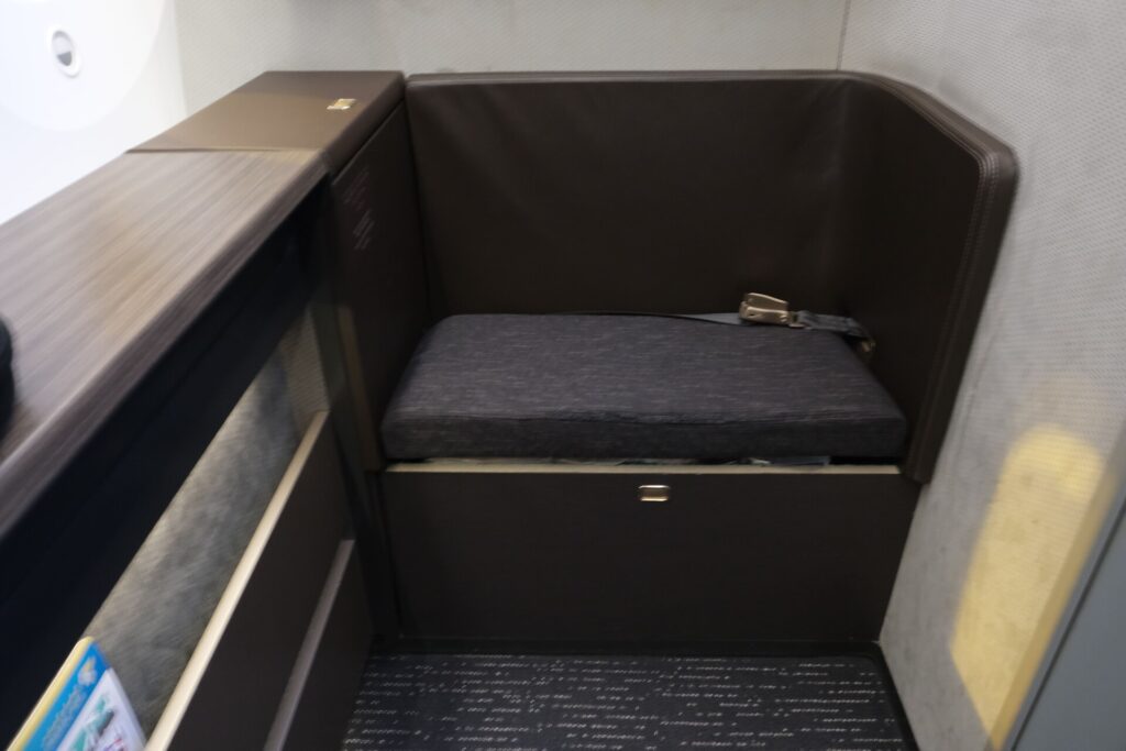 A front storage which can also be utilized as an extra seat in flight.