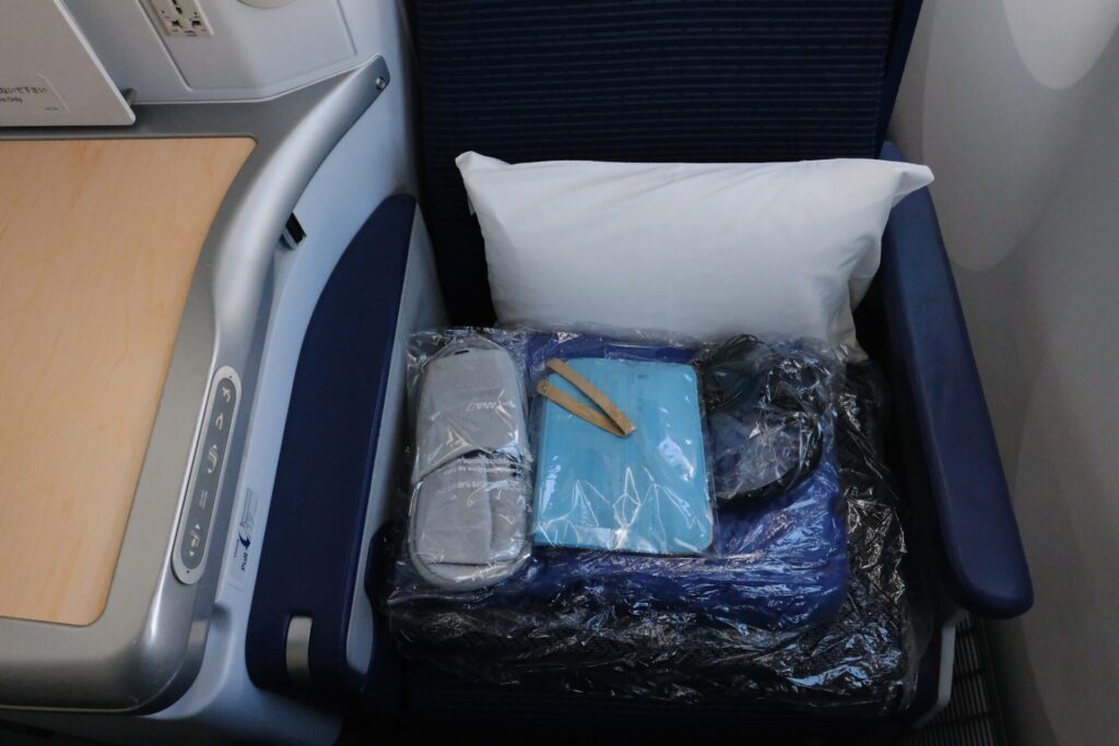 Storage is spacious though it is encroached in your leg room. A pillow and blanket set is provided.