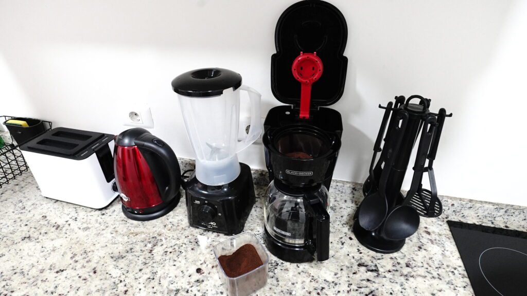 Coffee maker, toaster, utensils and blender. 
