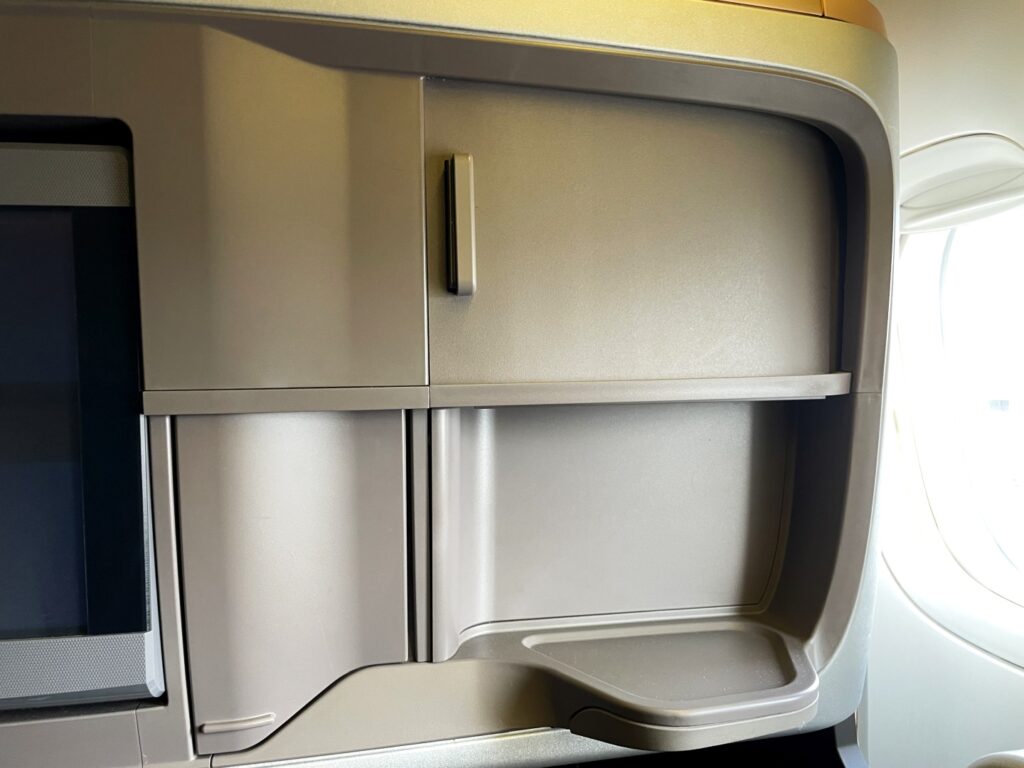 Drinks tray and two movable covers in front of the seat