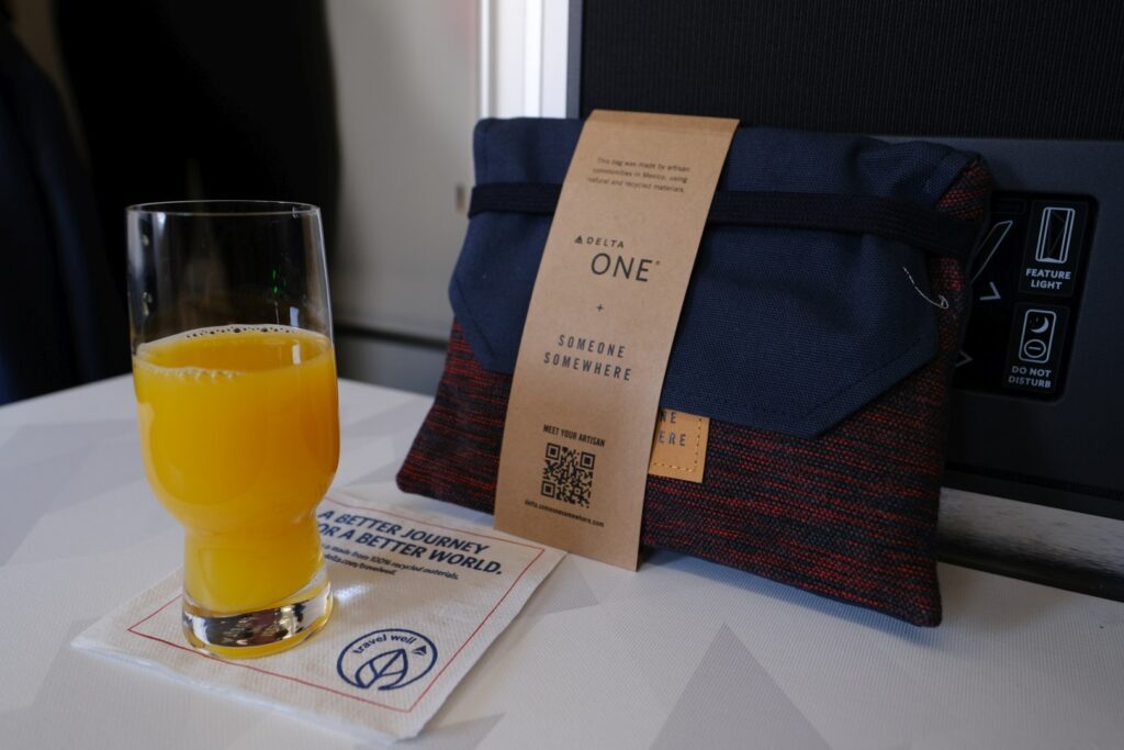 Delta One Business Class Amenity kit and OJ 