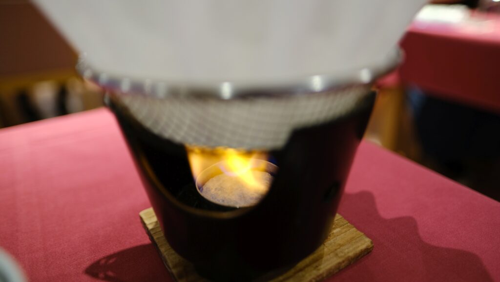 An attendant came to light the flame for the Shabu-shabu