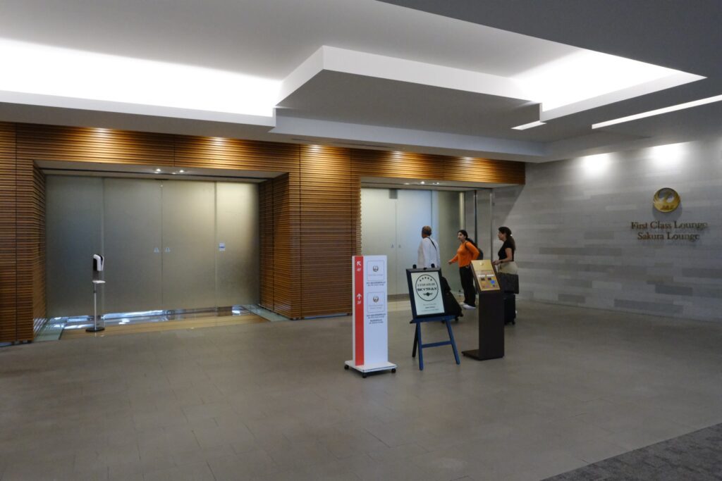The frosted glass entrance doors to the Sakura business class lounge