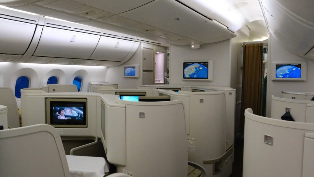 Forward bulk head of Vietnam Airlines Business class cabin with three TVs