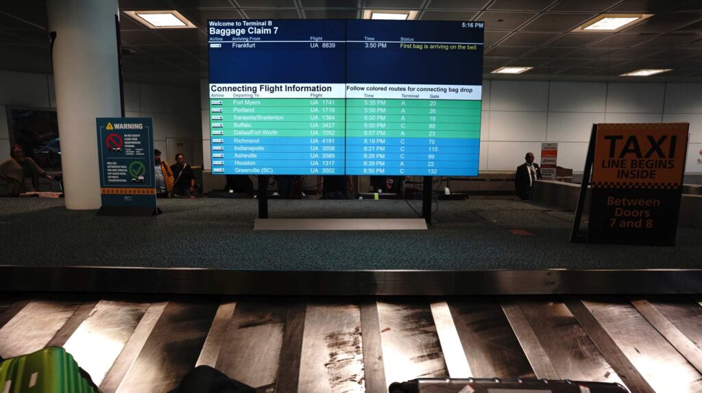 Baggage claim with connecting gate information shown at Newark EWR on arrival