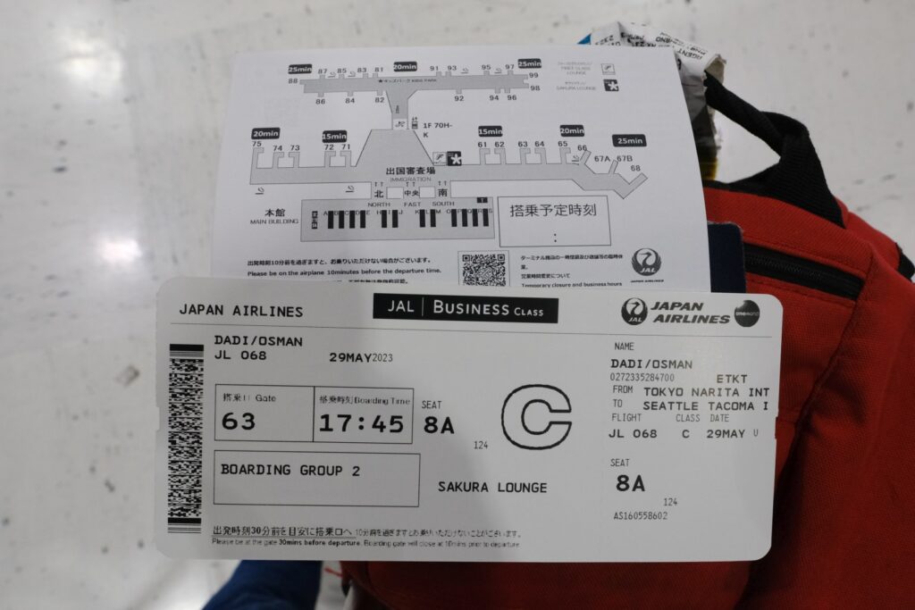 My Japan Airlines business class boarding card card and terminal map