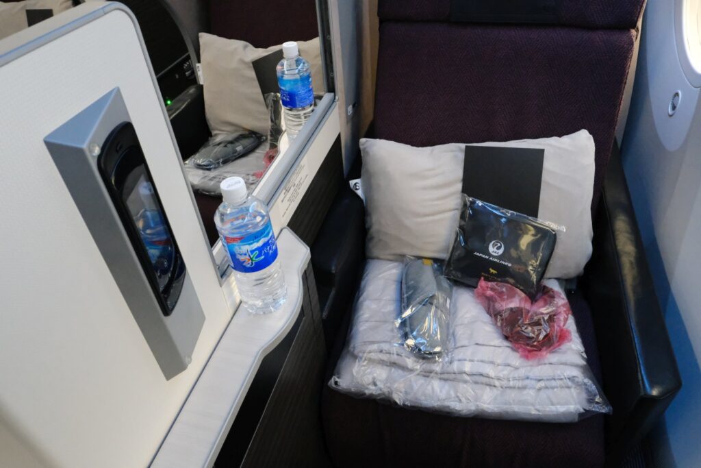 The seat with water, slippers, and other amenities